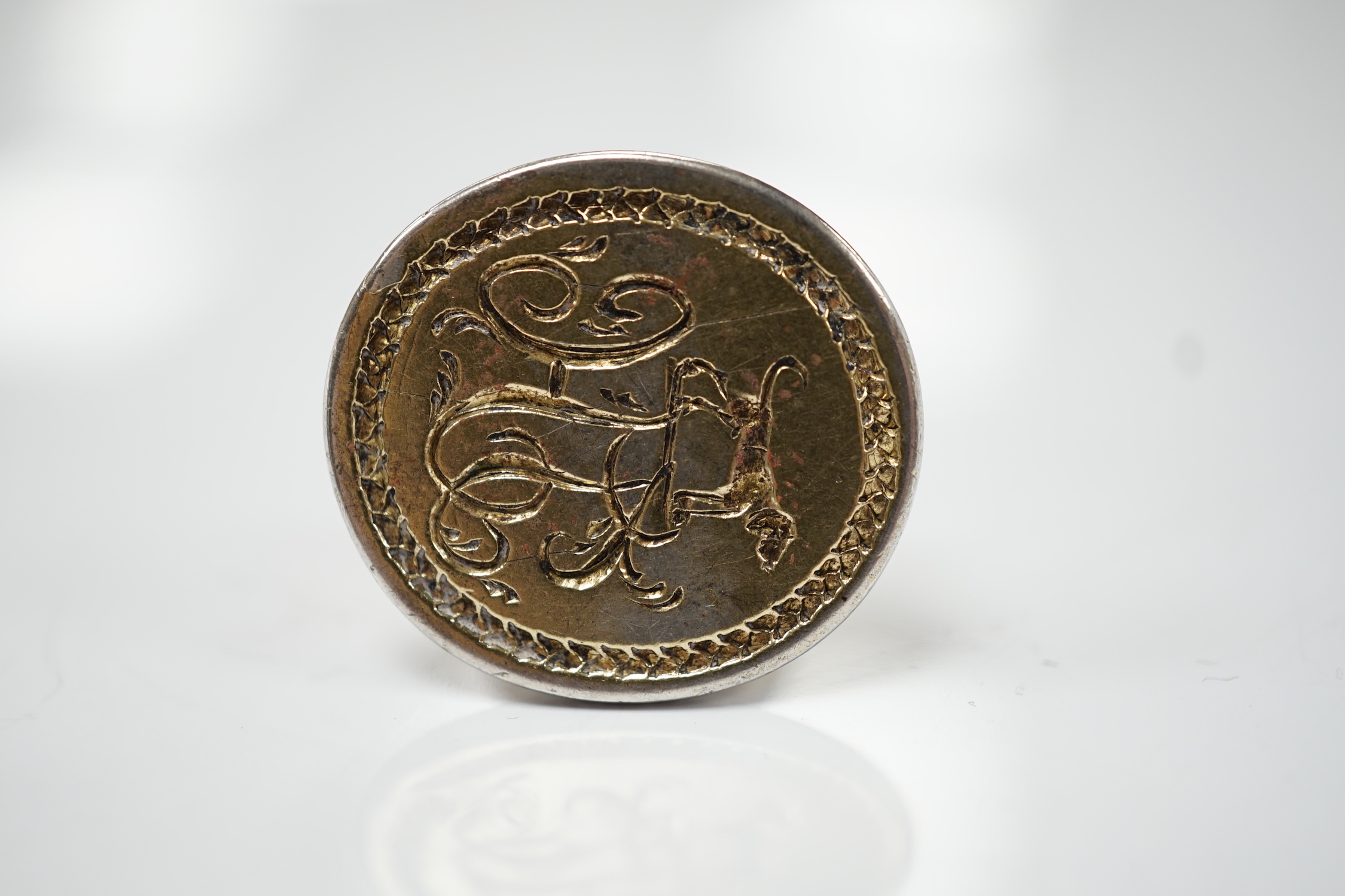 A George III parcel gilt silver fob seal, by Hester Bateman, London, circa 1770, 23mm, the matrix with crested monogram.